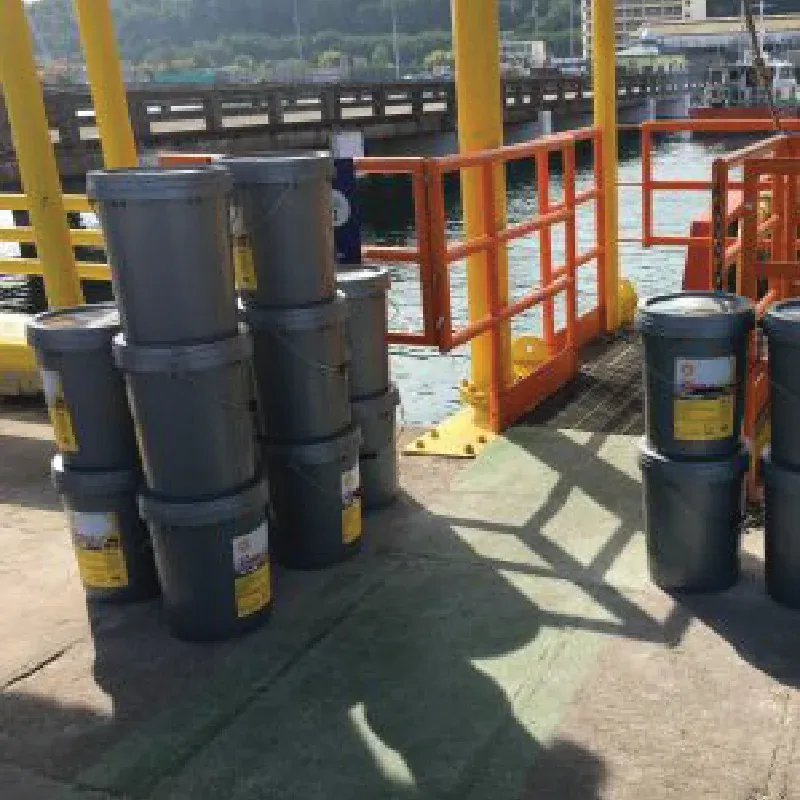 Drums of marine lubricant on the quay