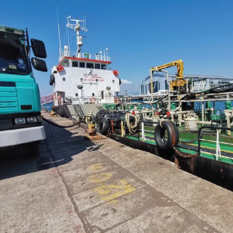 Tanker truck and bunker vessel at the quay