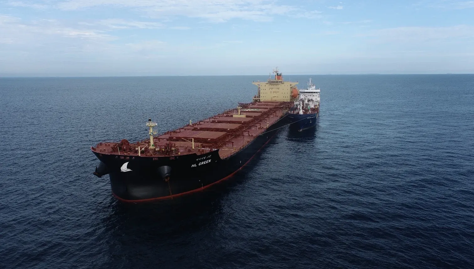 Aerial view of a bulk carrier with a bunker vessel alongside